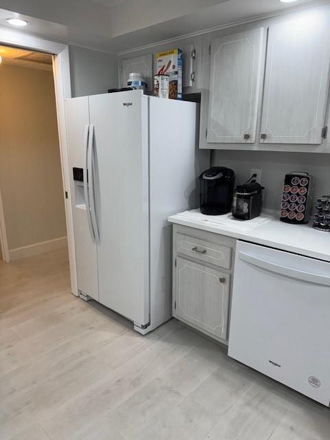 A kitchen features a white refrigerator, dishwasher, and cabinets with light wood-grain finishes — 111 N Pompano Beach Boulevard # 1005, Pompano Beach FL 33062, POMPANO BEACH, FL