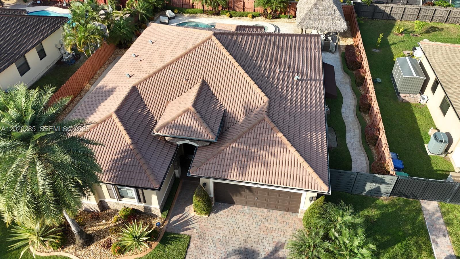An aerial view shows a house with a brown tile roof, a garage, and a pool — 15413 SW 116th Ter, Miami FL 33196, MIAMI, FL