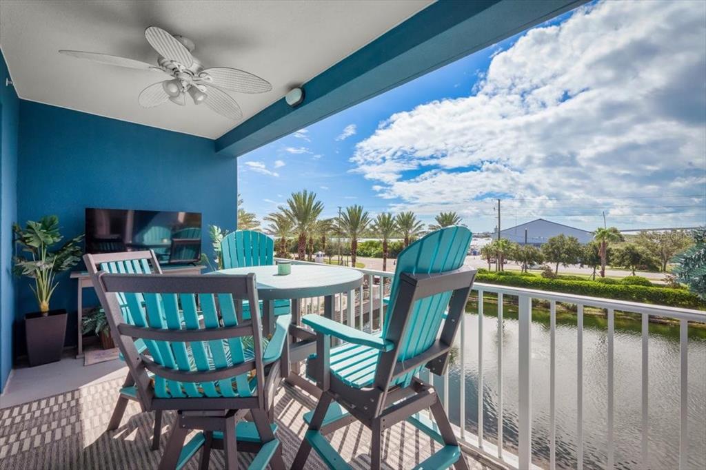 A balcony with a ceiling fan, outdoor furniture, and a view of a waterway — 1 RIVERWALK DRIVE UNIT 303, NEW SMYRNA BEACH, FL