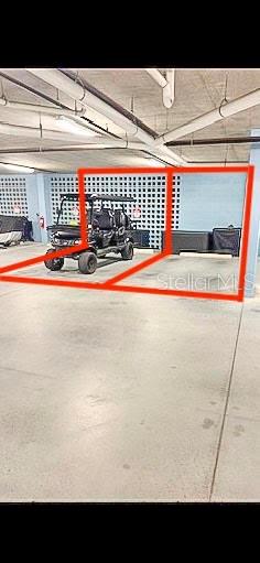 A covered parking area features two designated spaces, one currently occupied by a golf cart — 1 RIVERWALK DRIVE UNIT 303, NEW SMYRNA BEACH, FL