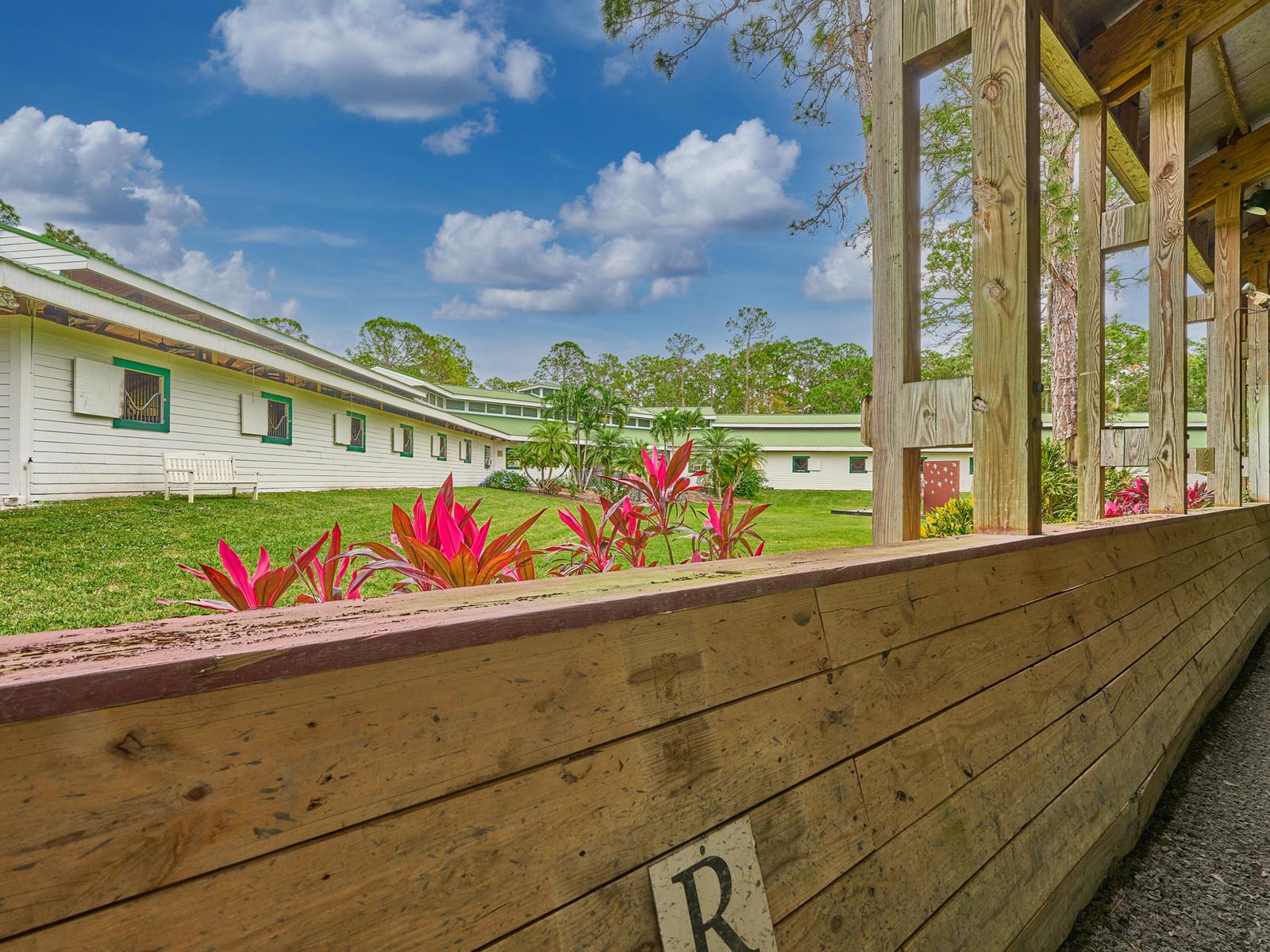 A brick walkway leads to the front entrance of a single-story house surrounded by palm trees — 18238 128th Trail N, Jupiter FL 33478, JUPITER, FL