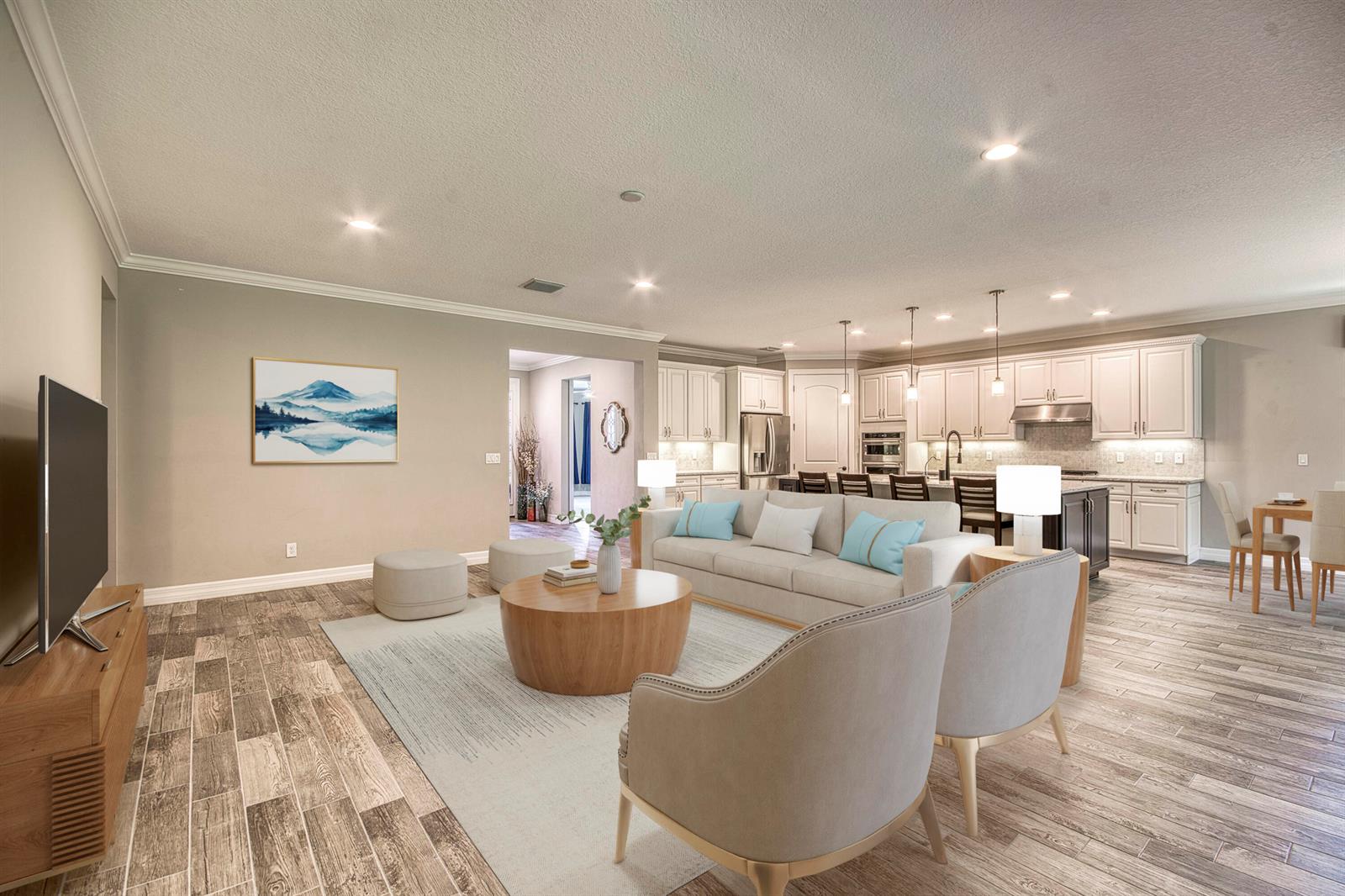 An open-concept living room and kitchen featuring light-colored furniture, wood-look tile floors, and white cabinetry — 134 Shores Pointe Drive, Jupiter FL 33458, JUPITER, FL