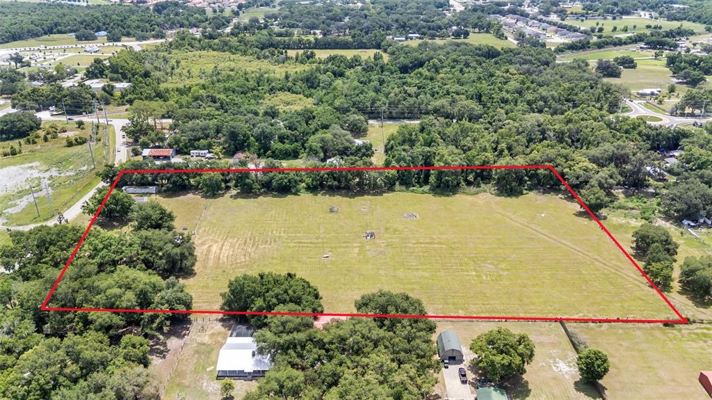 An aerial view shows a large, rectangular, grassy lot outlined in red — 3146 MOUNT TABOR ROAD, LAKELAND, FL