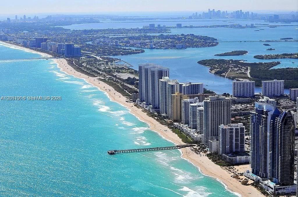 An aerial view of a coastal city with high-rise buildings along a sandy beach — 1830 S Ocean Dr # 4007, Hallandale Beach FL 33009, HALLANDALE BEACH, FL