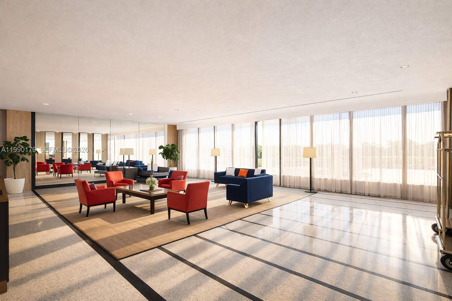 A spacious lobby features a seating area with red and blue furniture on a rug — 5838 Collins Ave # 7G, Miami Beach FL 33140, MIAMI BEACH, FL
