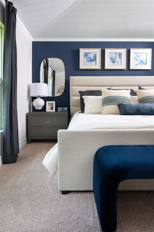 A bedroom features a navy accent wall, a beige upholstered bed, and a dark nightstand — 6075 SW 97TH PLACE, OCALA, FL