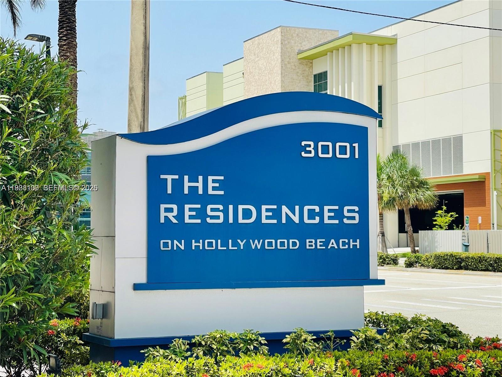 A blue and white monument sign displays the name of a residential building — 3001 S Ocean Dr # 101, Hollywood FL 33019, HOLLYWOOD, FL