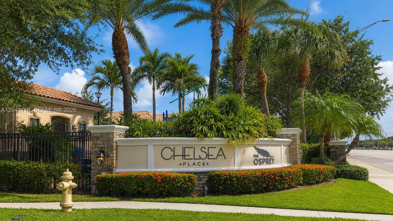 A stone monument sign for Chelsea Place stands in front of palm trees and landscaping — 5918 NW 56th Pl, Tamarac FL 33319, TAMARAC, FL