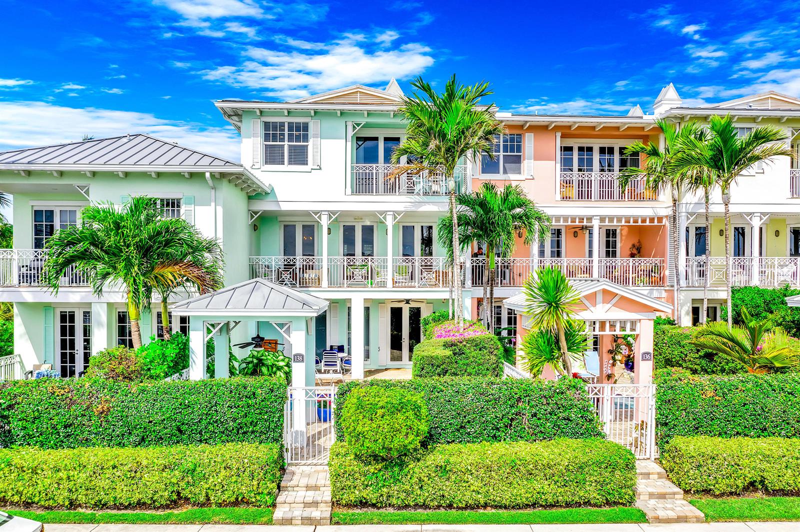 A multi-story residential building with pastel facades, balconies, and manicured hedges in front — 138 Marine Way, Delray Beach FL 33483, DELRAY BEACH, FL