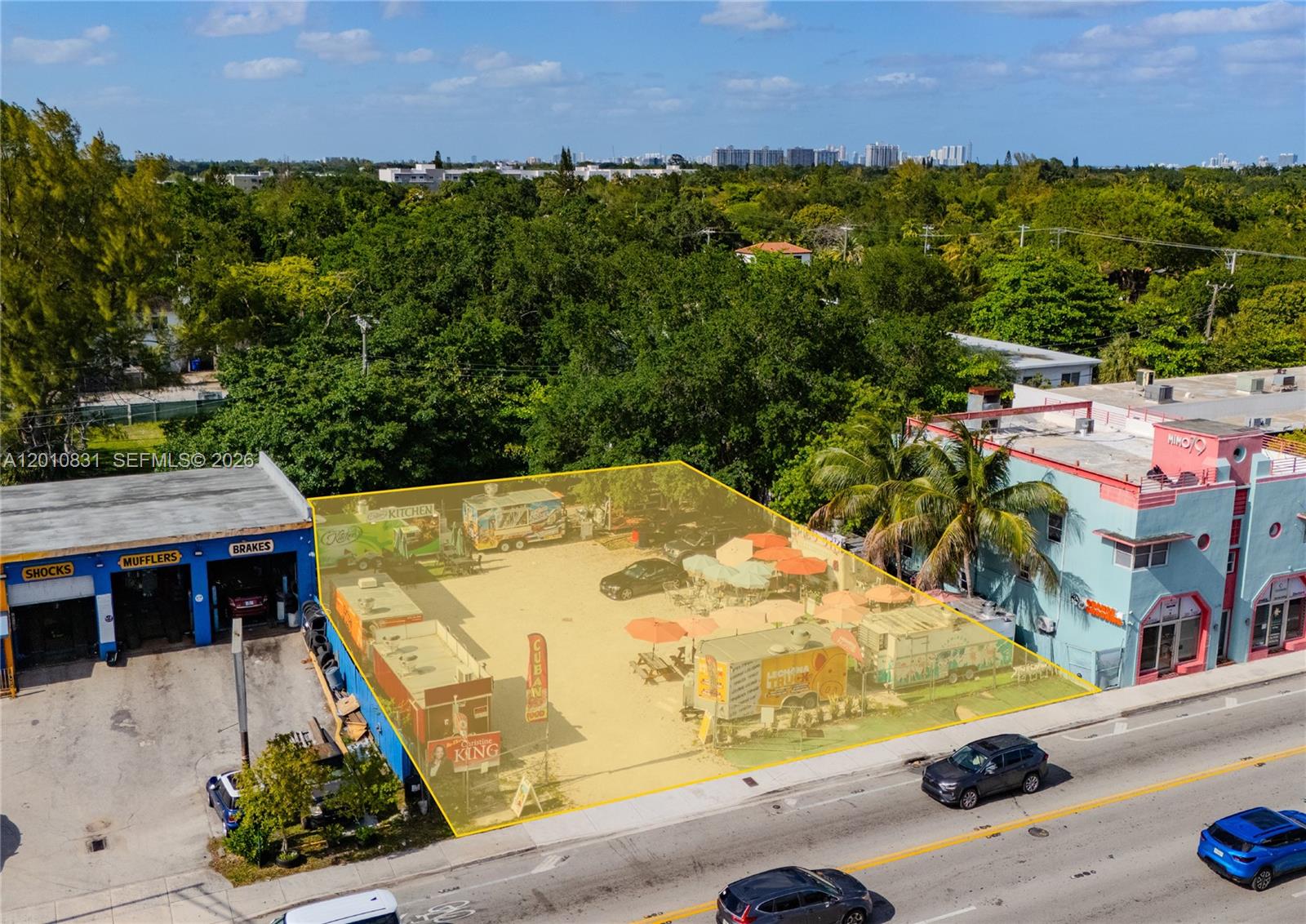 An aerial view shows a vacant lot with food trucks and outdoor seating between buildings — 633 NE 79th St, Miami FL 33138, MIAMI, FL