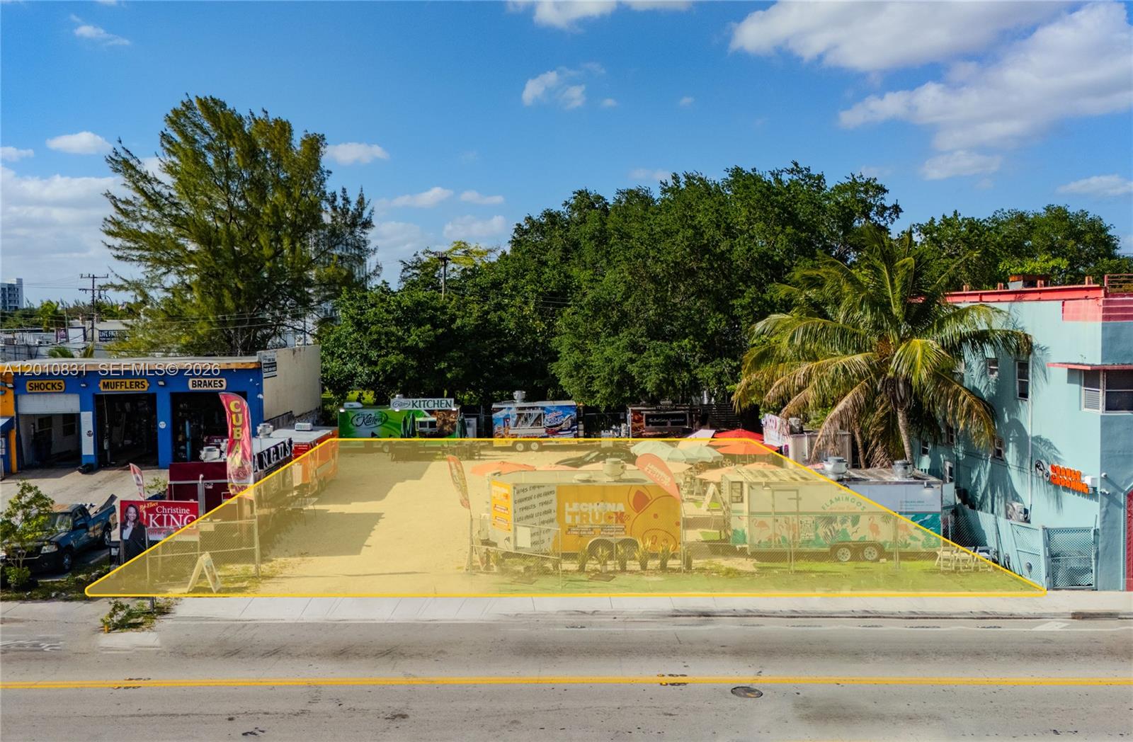 An aerial view shows a fenced, vacant lot occupied by several food trucks and seating — 633 NE 79th St, Miami FL 33138, MIAMI, FL