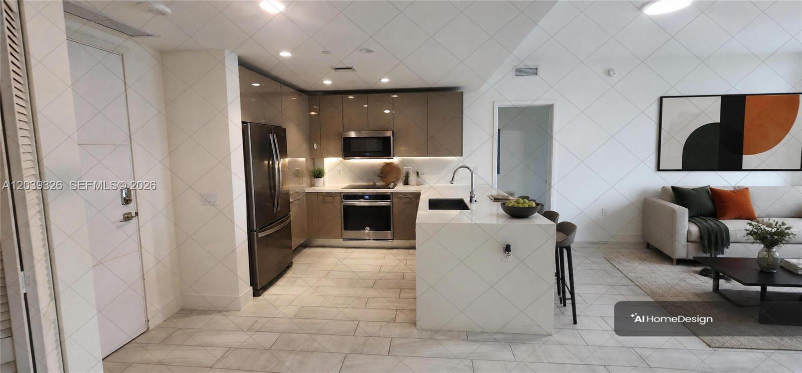 A modern kitchen with glossy brown cabinets and a white island opens to a living area — 2000 Metropica Way # 2106, Sunrise FL 33323, SUNRISE, FL