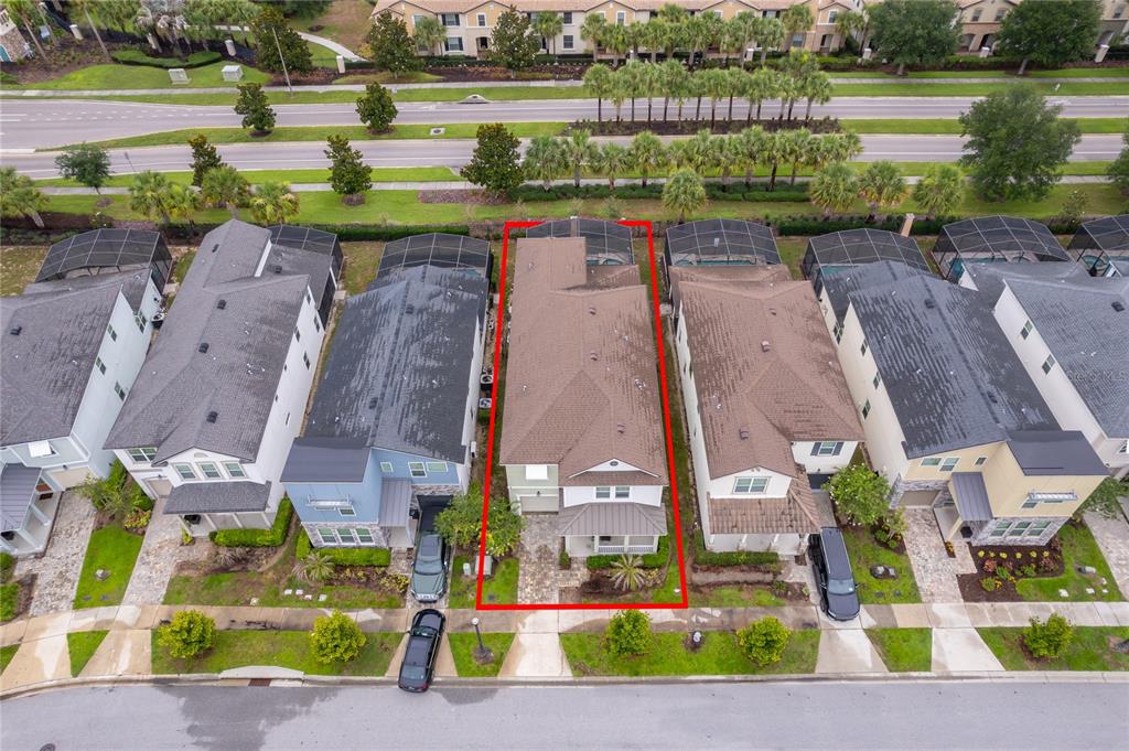 An aerial view shows a residential house outlined in red within a suburban neighborhood — 8951 AMELIA DOWNS TRAIL, KISSIMMEE, FL
