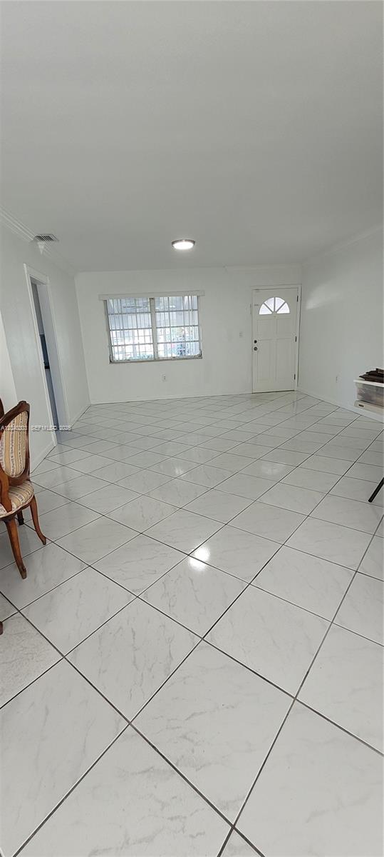 A bright room features white walls, large white floor tiles, and a white front door — 5200 SW 89th Pl, Miami FL 33165, MIAMI, FL