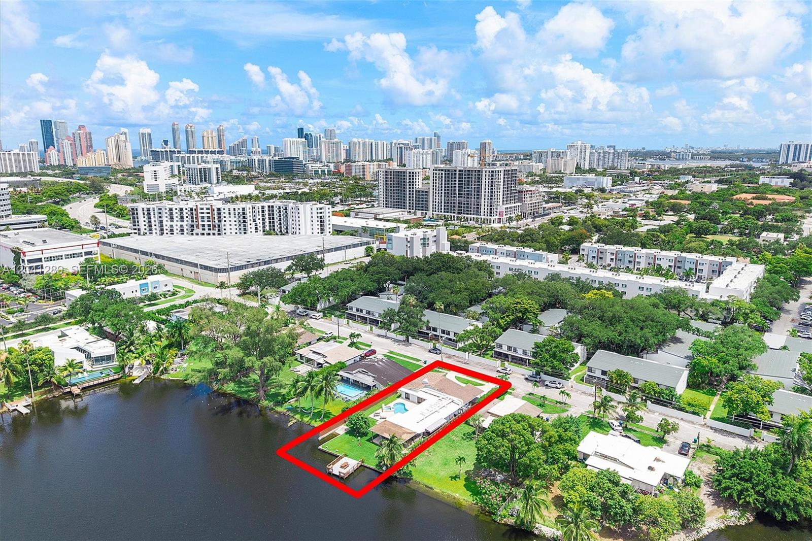 An aerial view shows a waterfront house with a pool and dock outlined in red — 2531 NE 195th St, Miami FL 33180, MIAMI, FL