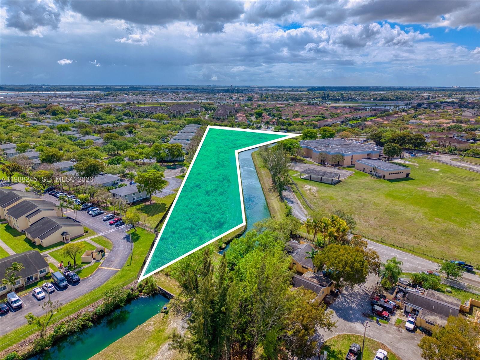 An aerial view shows a vacant, irregularly shaped plot of land highlighted in green — SW 272 ST, Miami FL 33032, MIAMI, FL