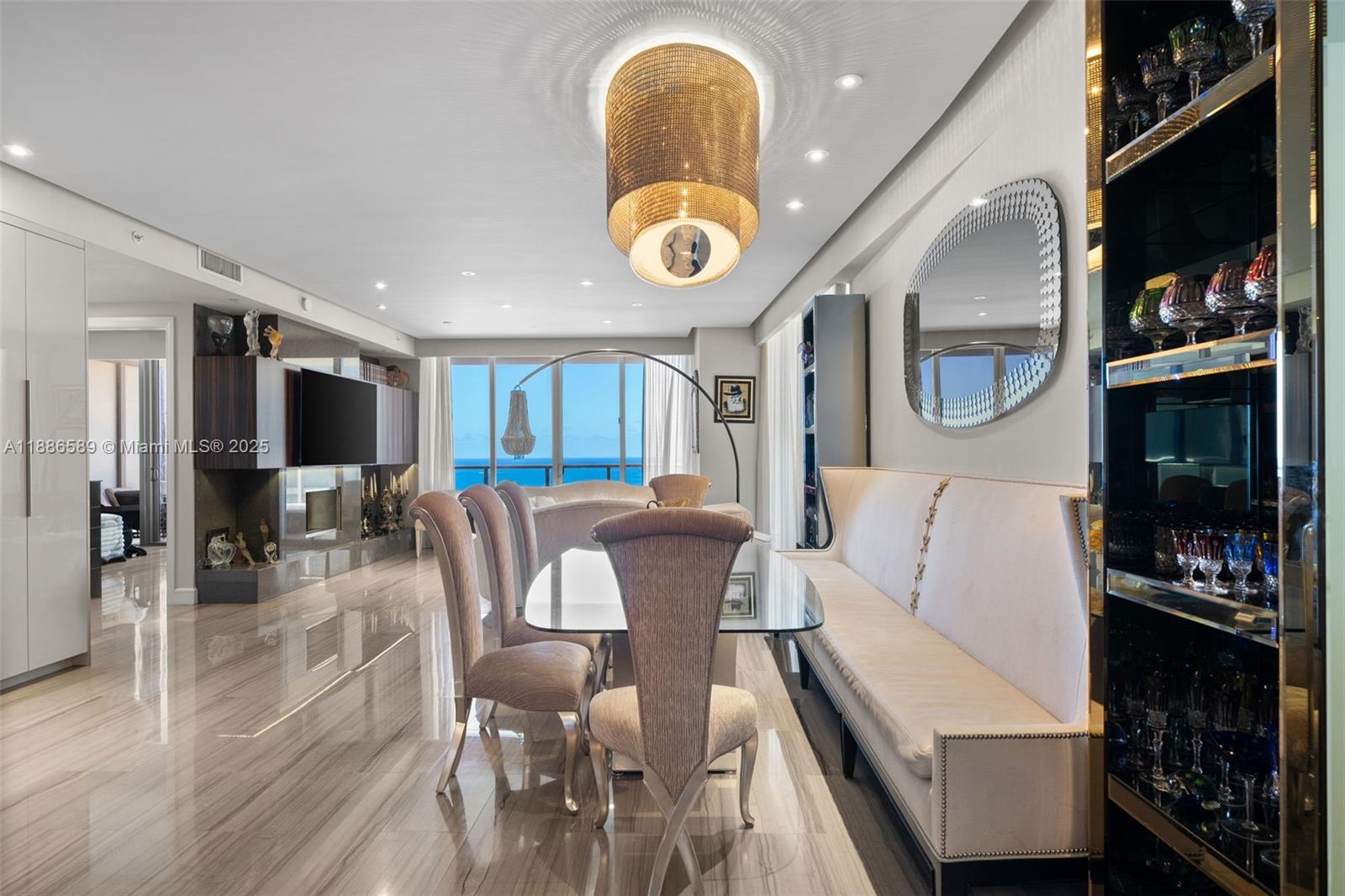 A dining room features a glass table, upholstered chairs, a bench, and ocean views — 9705 Collins Ave # 2304N, Bal Harbour FL 33154, BAL HARBOUR, FL