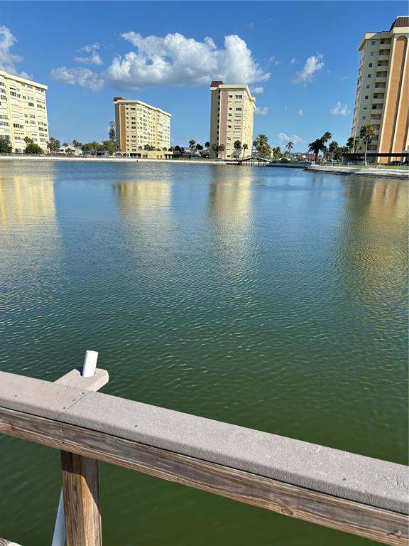 A view of a lake with several high-rise apartment buildings in the background — 4725 COVE CIRCLE UNIT 104, ST PETERSBURG, FL