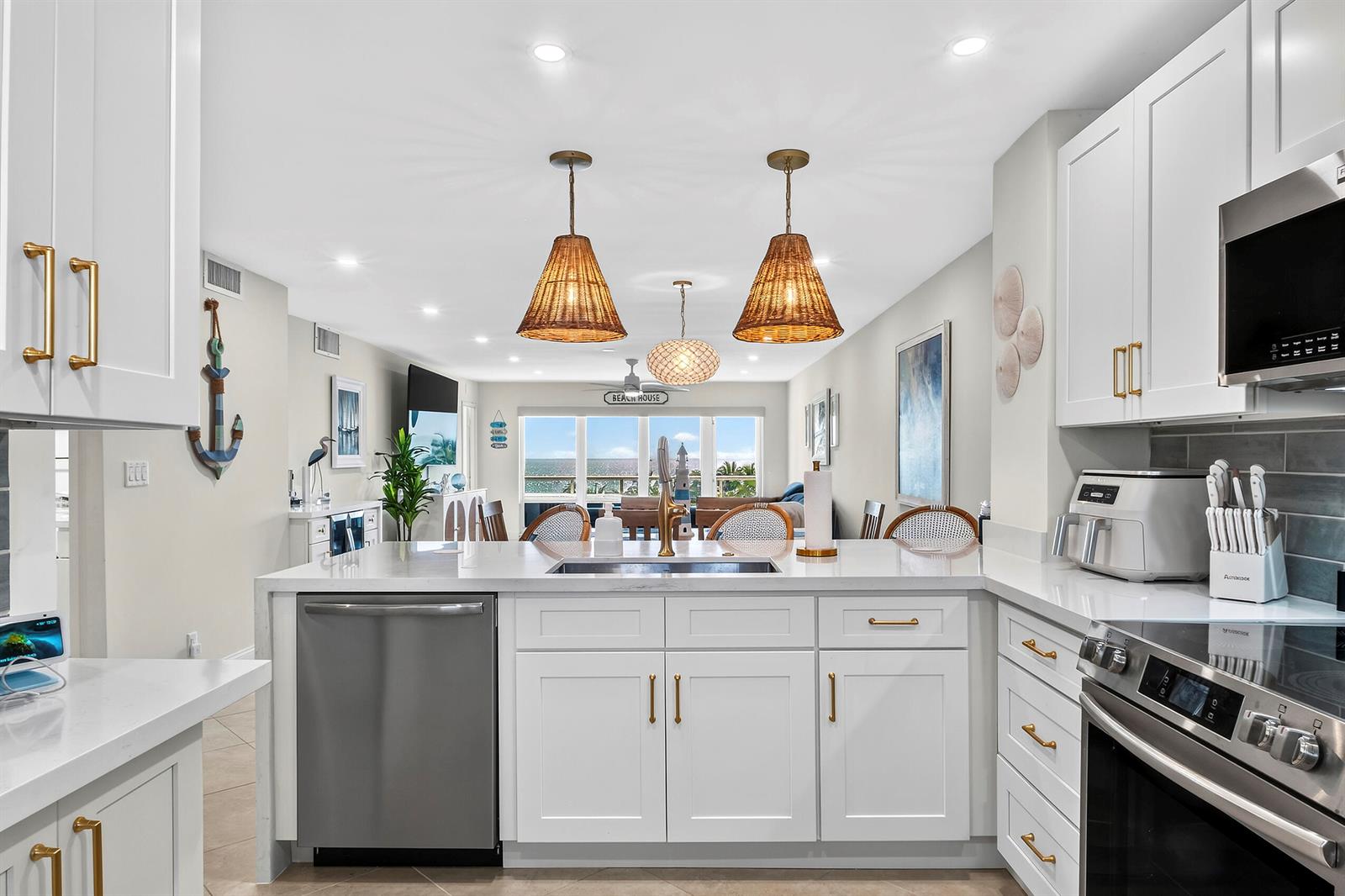 A bright kitchen with white cabinets, stainless steel appliances, and a view of the ocean — 111 N Pompano Beach Boulevard # 611, Pompano Beach FL 33062, POMPANO BEACH, FL