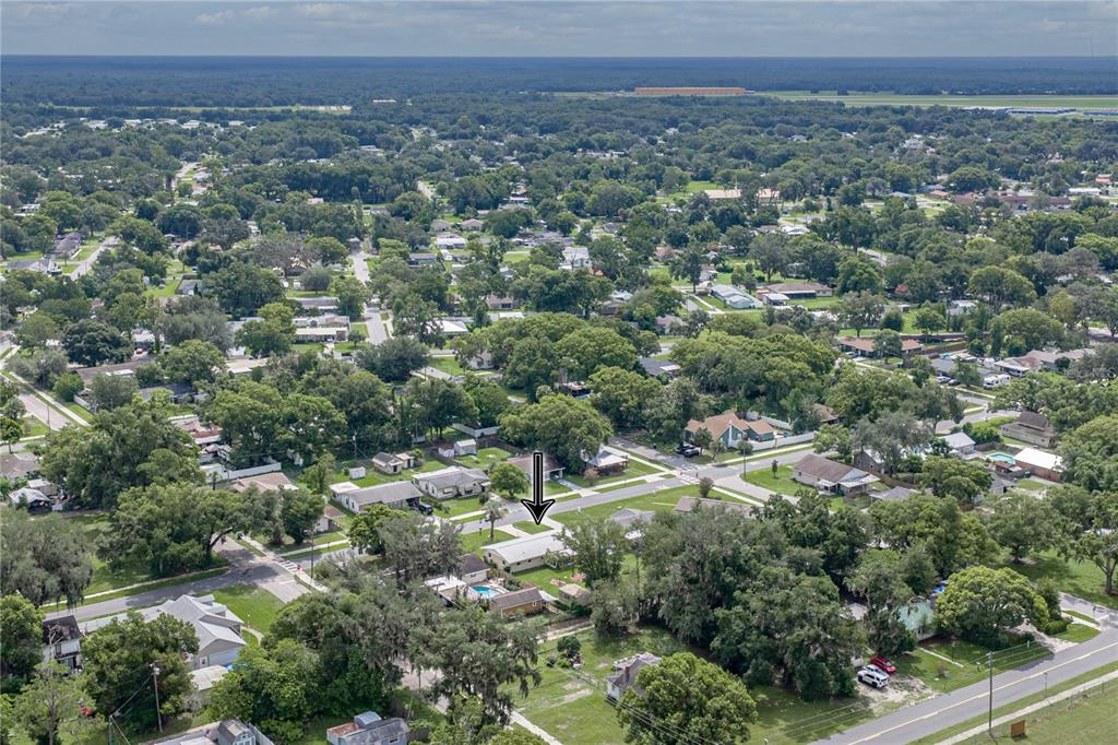 An aerial view shows a single-story house marked by an arrow in a suburban neighborhood — 5745 13TH STREET, ZEPHYRHILLS, FL
