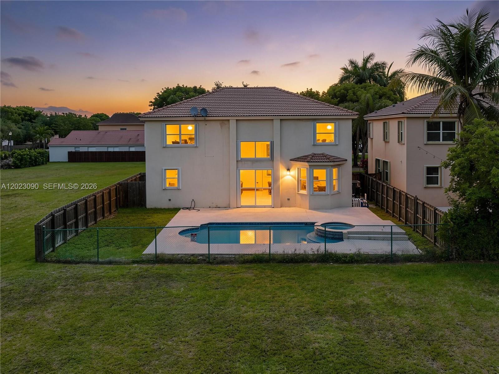 A two-story house with a backyard pool and spa at sunset — 1730 SE 20th Ter, Homestead FL 33035, HOMESTEAD, FL