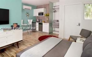 This studio apartment features a kitchenette, a bed, and a television on a white dresser — 1816 Meridian Ave # 5, Miami Beach FL 33139, MIAMI BEACH, FL