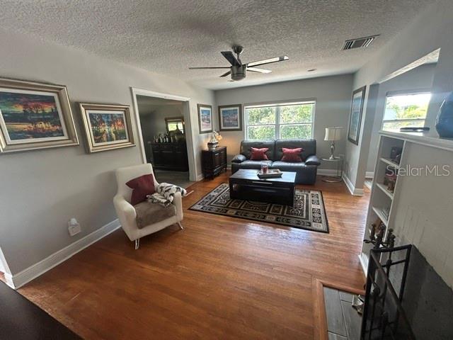 A living room features hardwood floors, a ceiling fan, a sofa, and an armchair — 428 ALTALOMA AVENUE, ORLANDO, FL