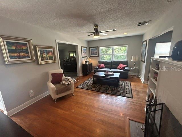 A living room with hardwood floors, a ceiling fan, a sofa, and an armchair — 428 ALTALOMA AVENUE, ORLANDO, FL