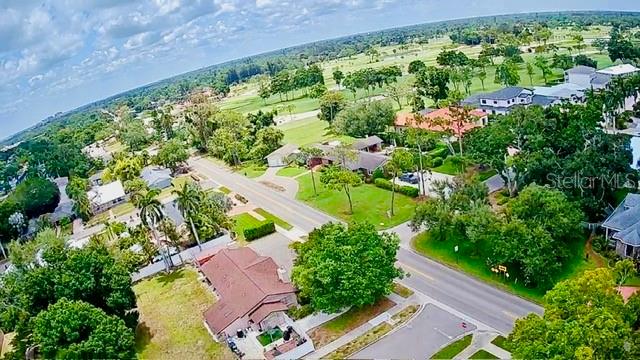 A gray single-story house with a two-car garage sits on a grassy lot with palm trees — 5000 9TH AVENUE W, BRADENTON, FL