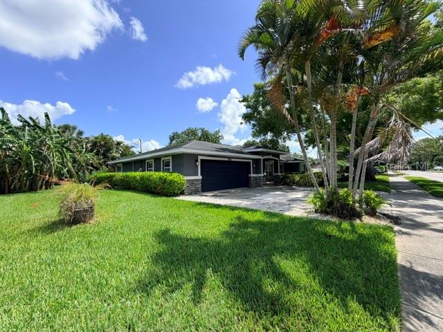 An aerial view shows a suburban neighborhood with houses, green lawns, and a golf course — 5000 9TH AVENUE W, BRADENTON, FL