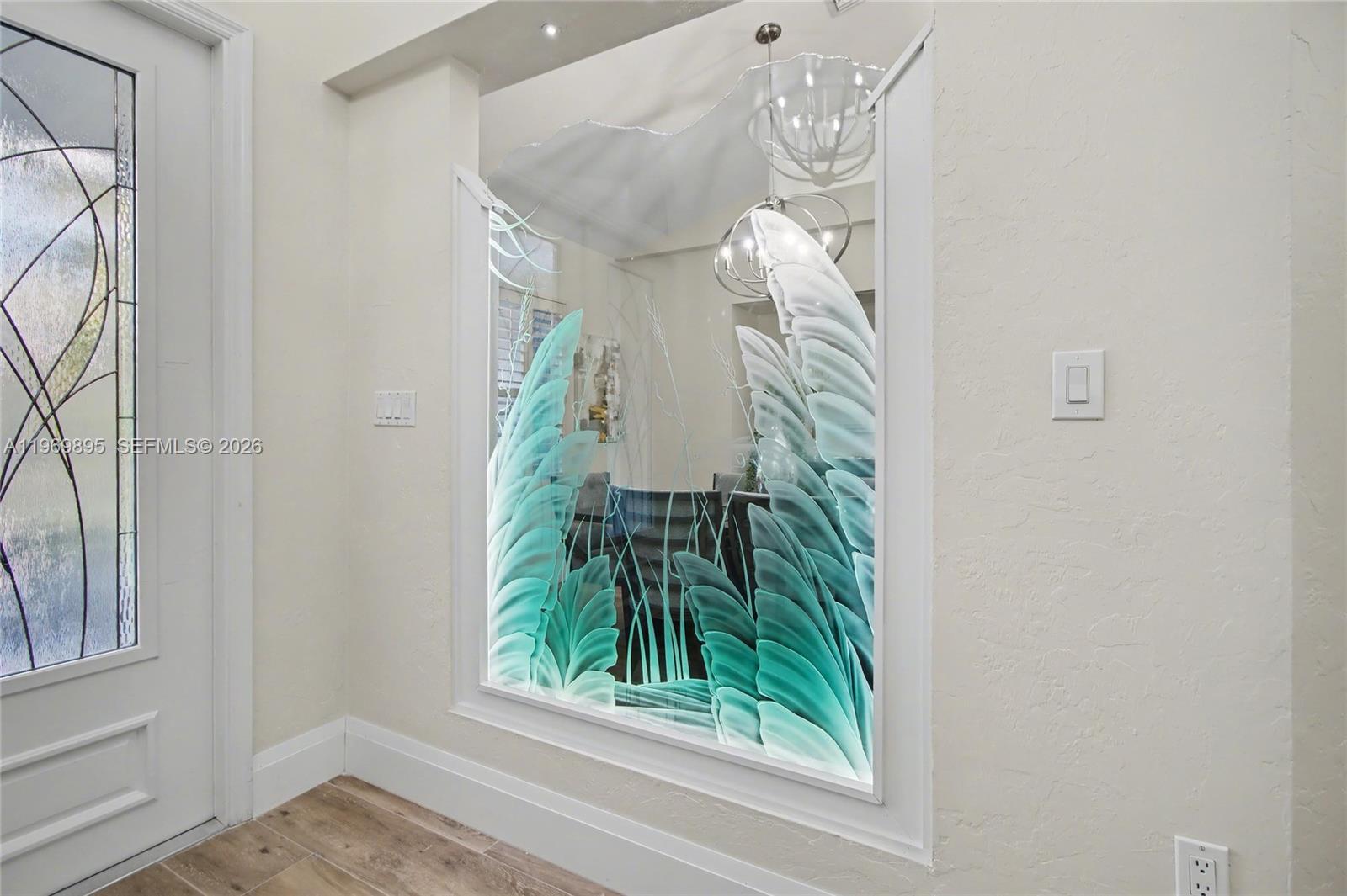An entryway features a large, decorative etched glass panel with a teal leaf design — 5186 Tallowood Way, Naples FL 34116, NAPLES, FL