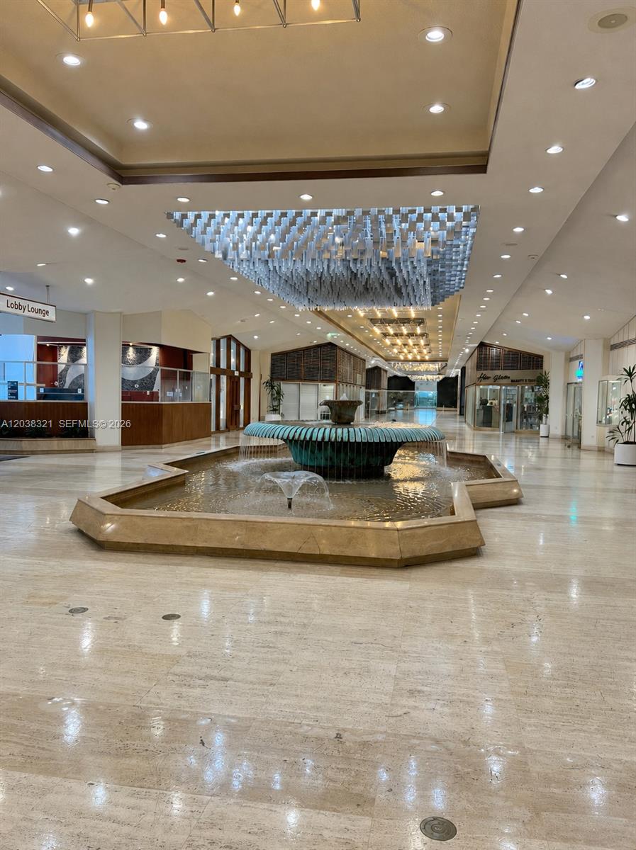 A large indoor lobby features a central tiered fountain, marble flooring, and decorative ceiling lights — 801 Brickell Bay Dr # 364, Miami FL 33131, MIAMI, FL