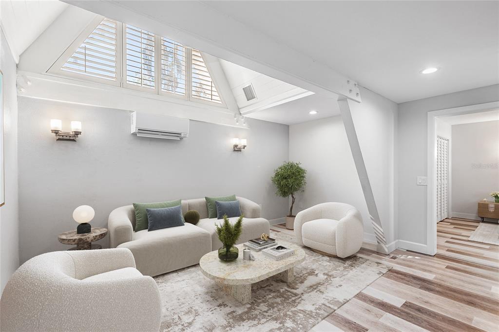 A living room features a vaulted ceiling, a white sofa, two armchairs, and wood flooring — 1817 BEACHWAY LN, ODESSA, FL
