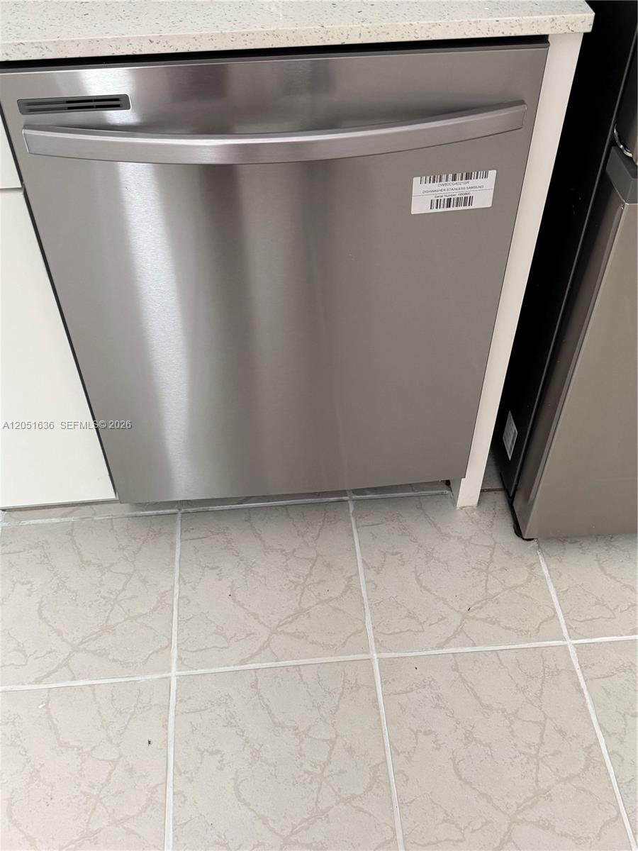 A stainless steel Samsung dishwasher is installed under a light-colored countertop in a kitchen — 4007 N Cypress Dr # 203, Pompano Beach FL 33069, POMPANO BEACH, FL