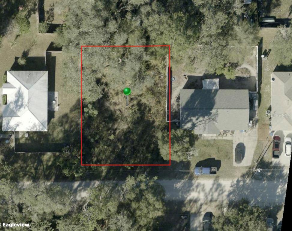 An aerial view shows a rectangular vacant lot outlined in red between two residential houses — 1285 6TH STREET, ORANGE CITY, FL
