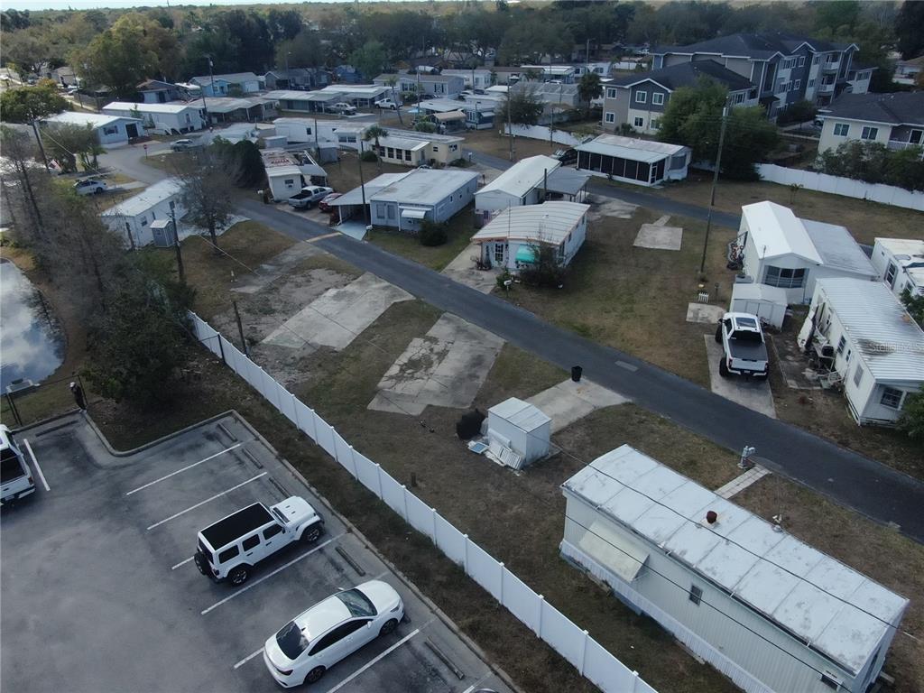 An aerial view shows a mobile home park with several trailers, vacant concrete pads, and parking — 6720 PARK BOULEVARD N UNIT 20, PINELLAS PARK, FL