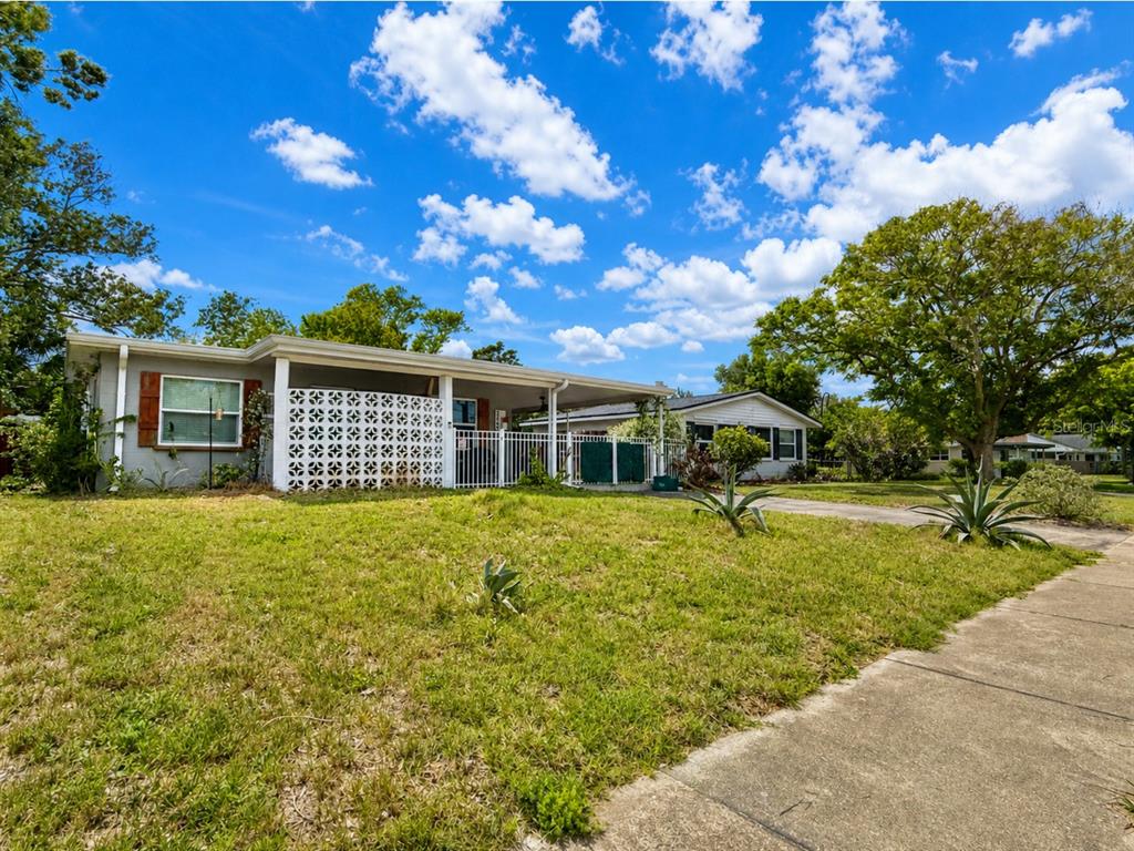 A single-story house with a white lattice porch and a fenced front yard — 2440 ANASTASIA DRIVE, SOUTH DAYTONA, FL