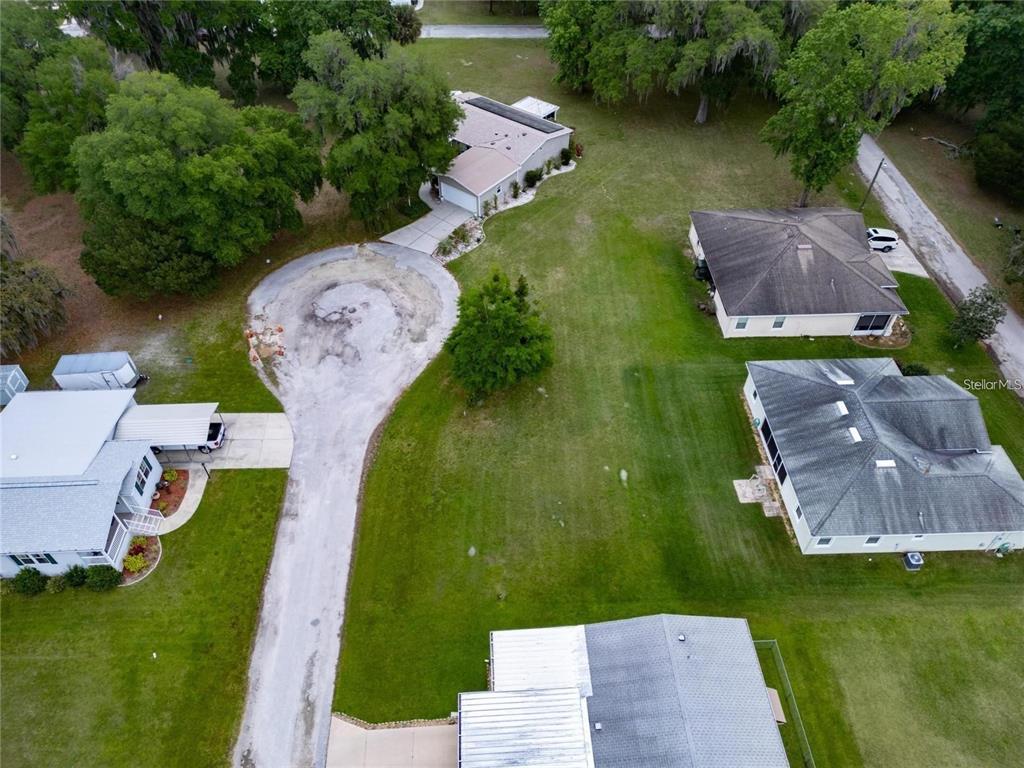 An aerial view shows several houses surrounded by green lawns and mature trees — LOT 25 BLK D STRATFORD COURT, WILDWOOD, FL