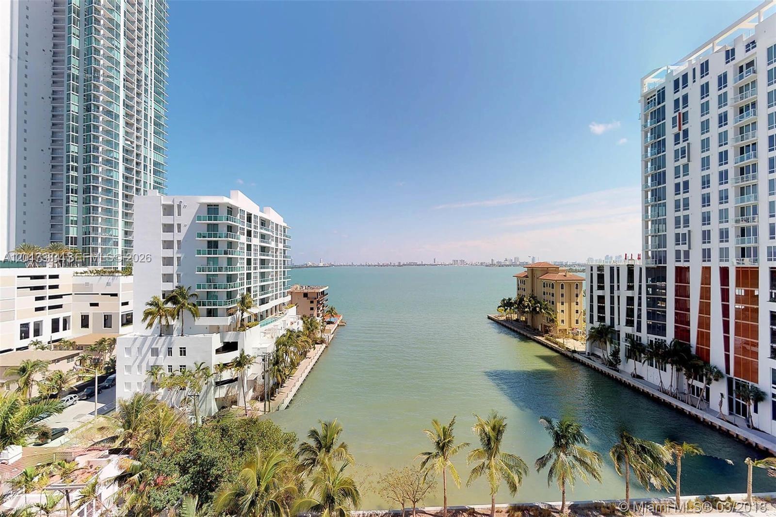 An elevated view shows a waterway between two modern apartment buildings leading to a bay — 460 NE 28th ST # 1102, Miami FL 33132, MIAMI, FL