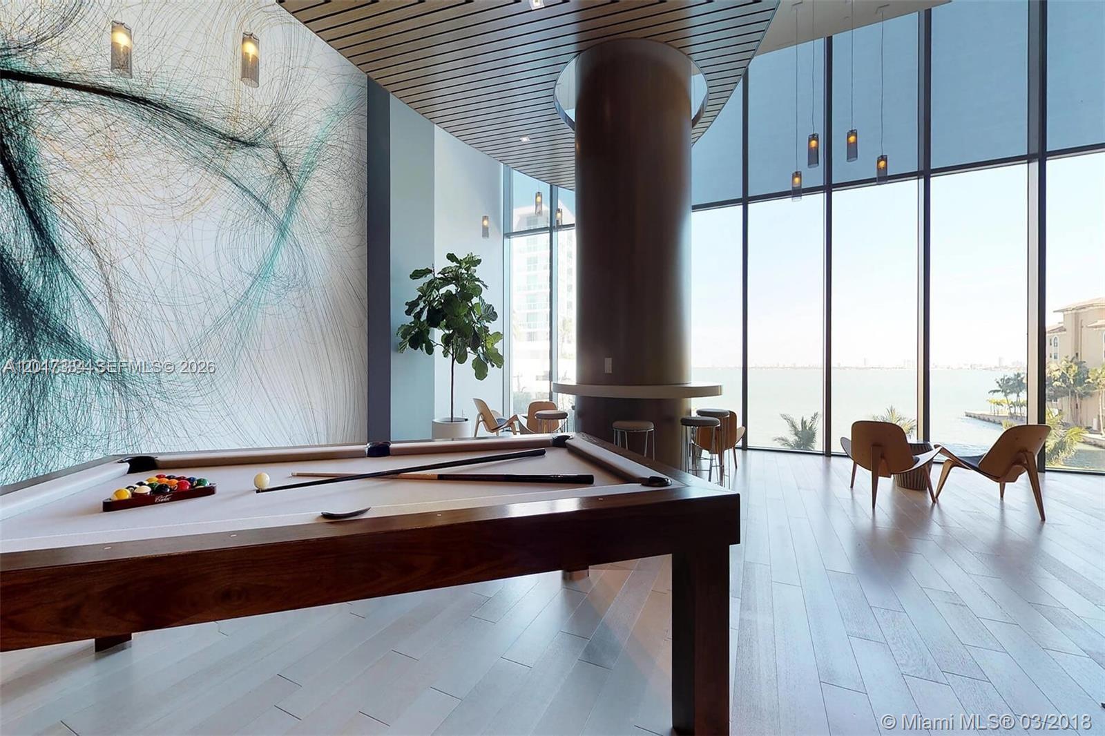 A modern lounge features a pool table, floor-to-ceiling windows, and a large abstract wall mural — 460 NE 28th ST # 1102, Miami FL 33132, MIAMI, FL