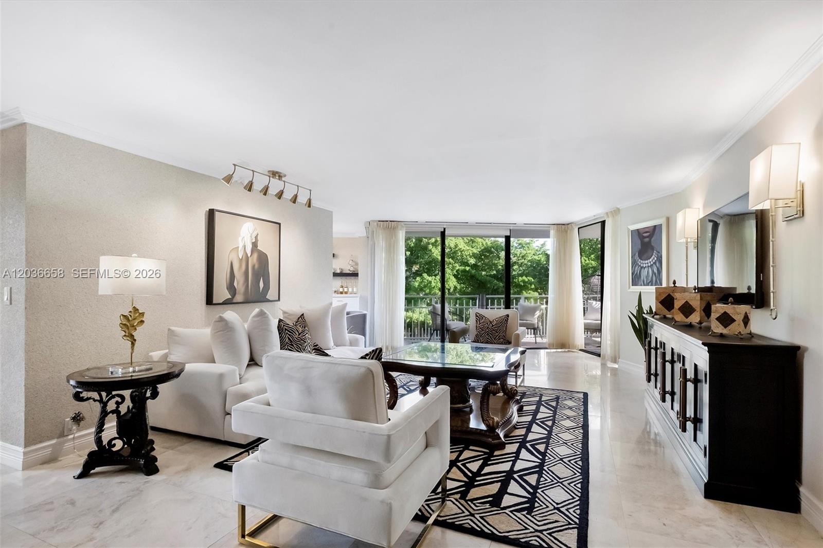 An aerial view shows a swimming pool and hot tub surrounded by trees and buildings — 1000 Quayside Ter # 411, Miami FL 33138, MIAMI, FL