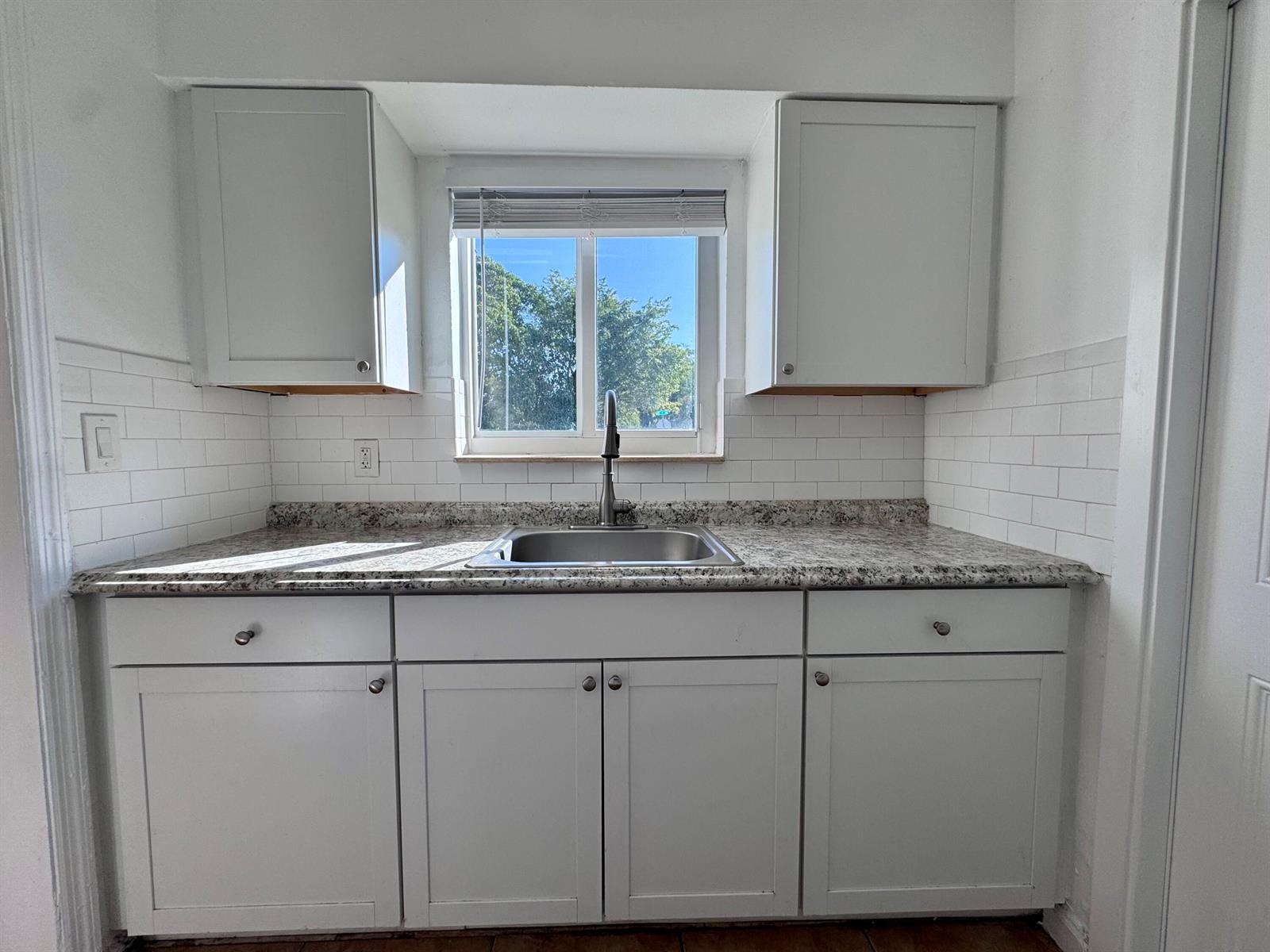 A bathroom features a white vanity, a toilet, and a bathtub with brown tiled walls — 3101 NE 7th Avenue # B, Pompano Beach FL 33064, POMPANO BEACH, FL