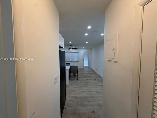 A view from a hallway looking into a living area with wood-look flooring — 500 Layne Blvd # 19, Hallandale Beach FL 33009, HALLANDALE BEACH, FL