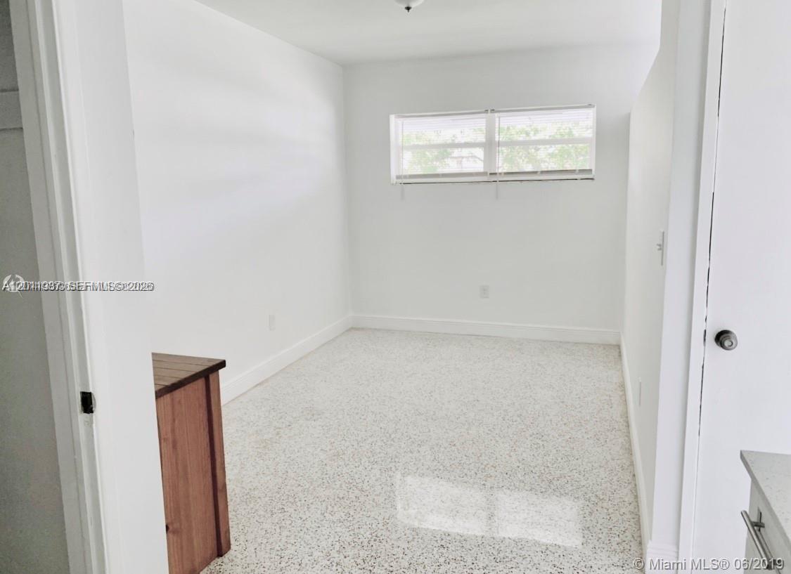 An empty room with white walls, a window with blinds, and speckled terrazzo flooring — 7731 NW 2nd Ave # 6, Miami FL 33150, MIAMI, FL