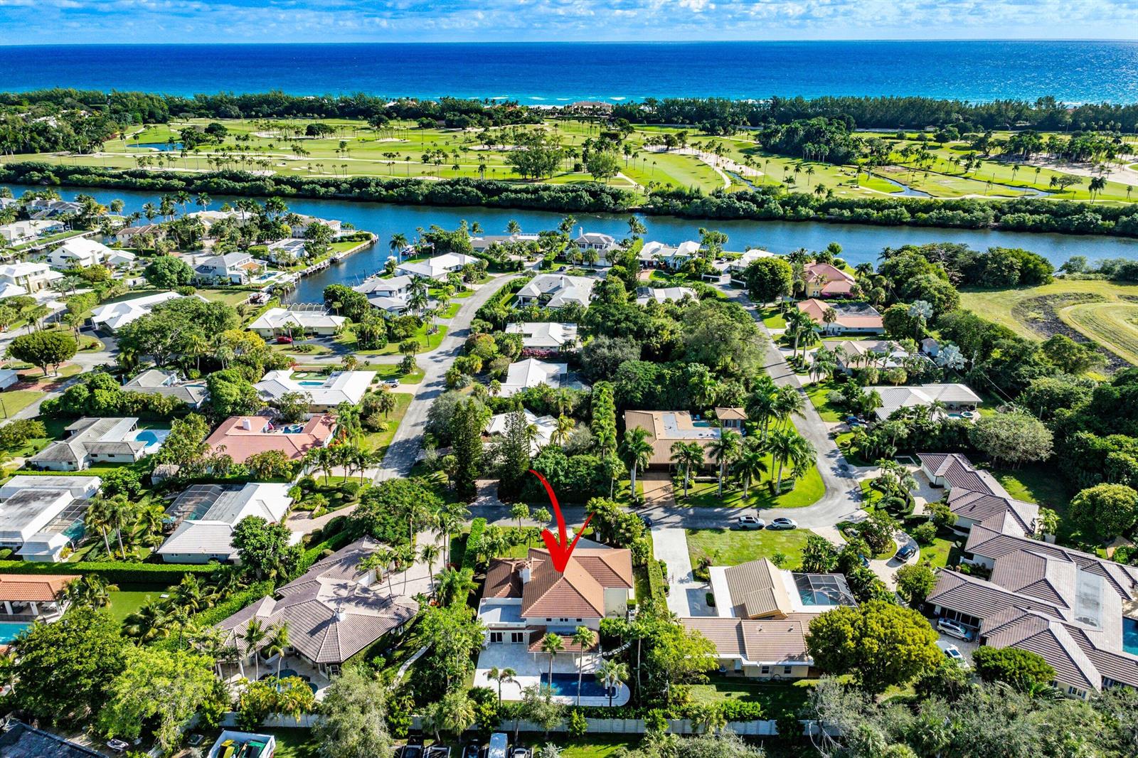 An aerial view shows a residential neighborhood with a red-roofed house highlighted by an arrow — 2570 Avenue Au Soleil, Delray Beach FL 33483, DELRAY BEACH, FL