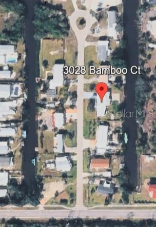 This is an aerial map view of a residential street with homes along a canal — 3028 BAMBOO COURT, PUNTA GORDA, FL