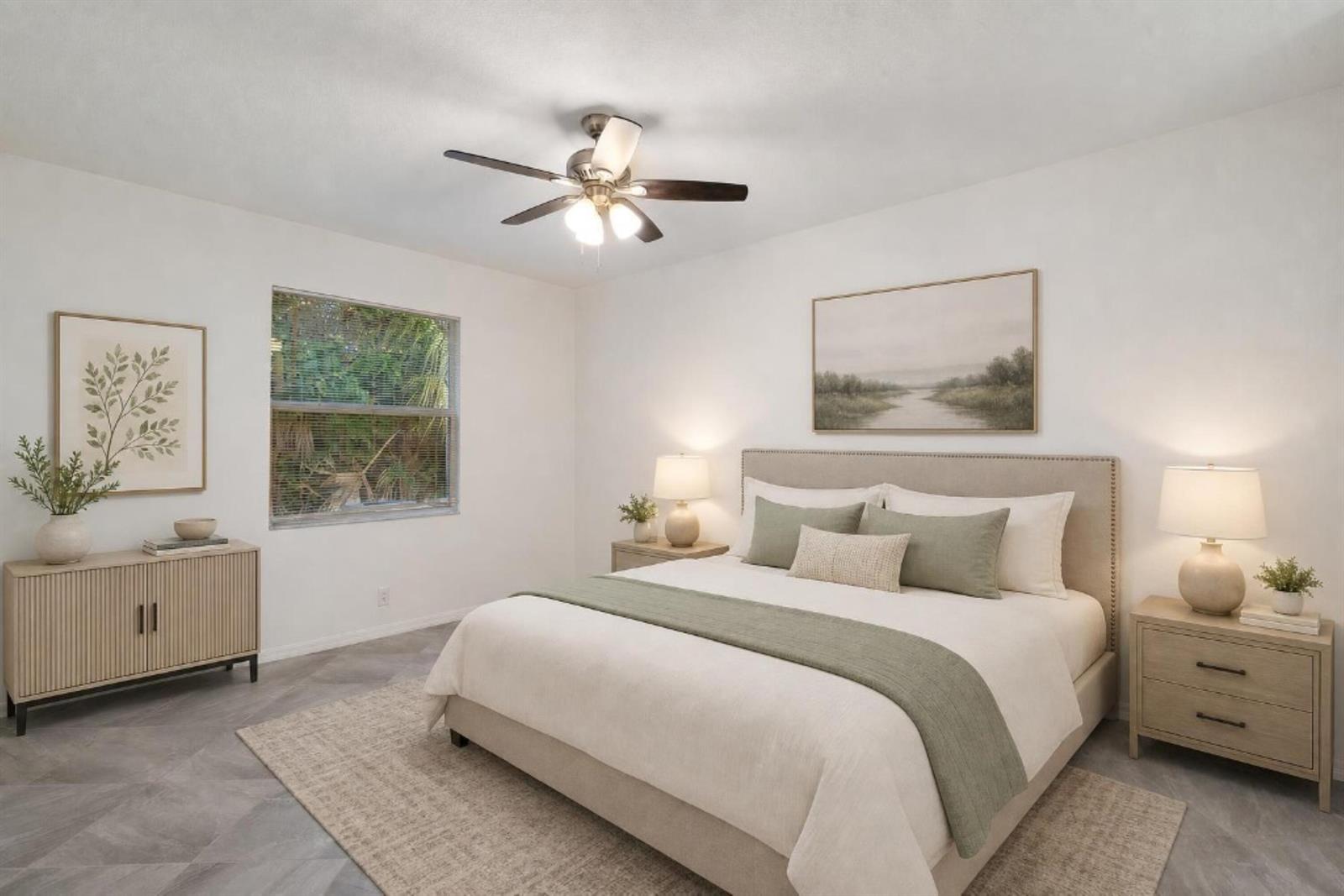 A bedroom features a bed with green accents, two nightstands, a dresser, and a ceiling fan — 2055 46th Avenue, Vero Beach FL 32966, VERO BEACH, FL