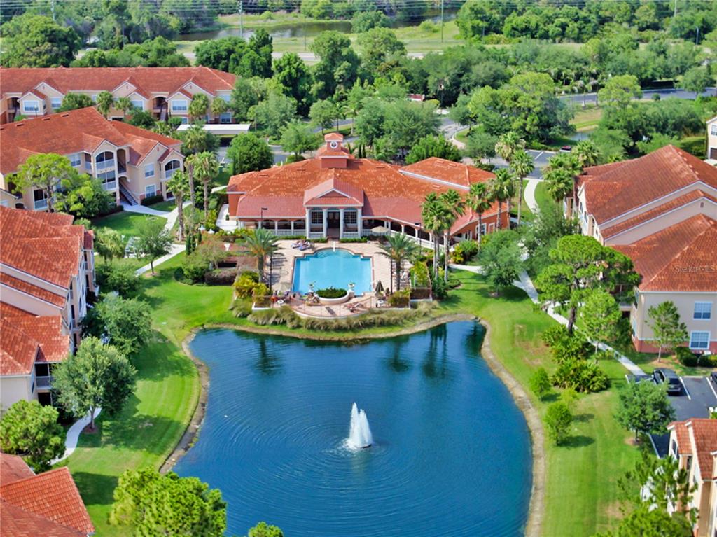 An aerial view shows a residential complex with a central pool and a pond fountain — 4134 CENTRAL SARASOTA PARKWAY UNIT 1735, SARASOTA, FL