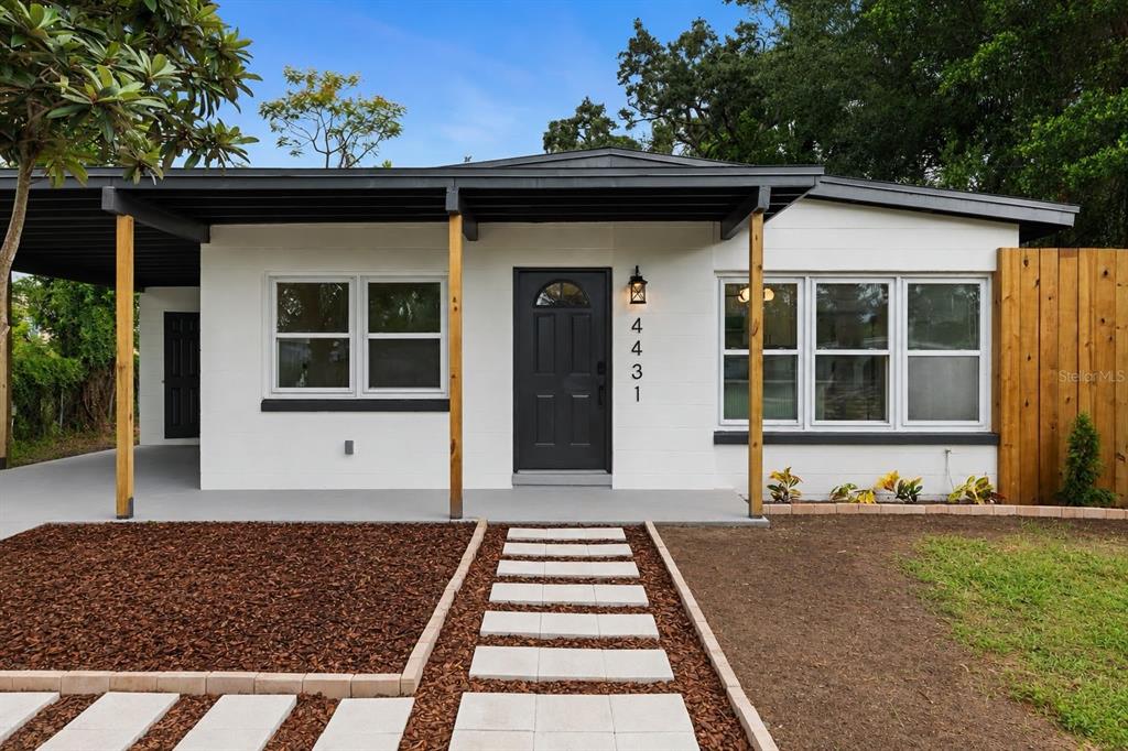 A single-story house with a white exterior, dark trim, and a covered front porch — 4431 SOUTHMORE DRIVE, ORLANDO, FL