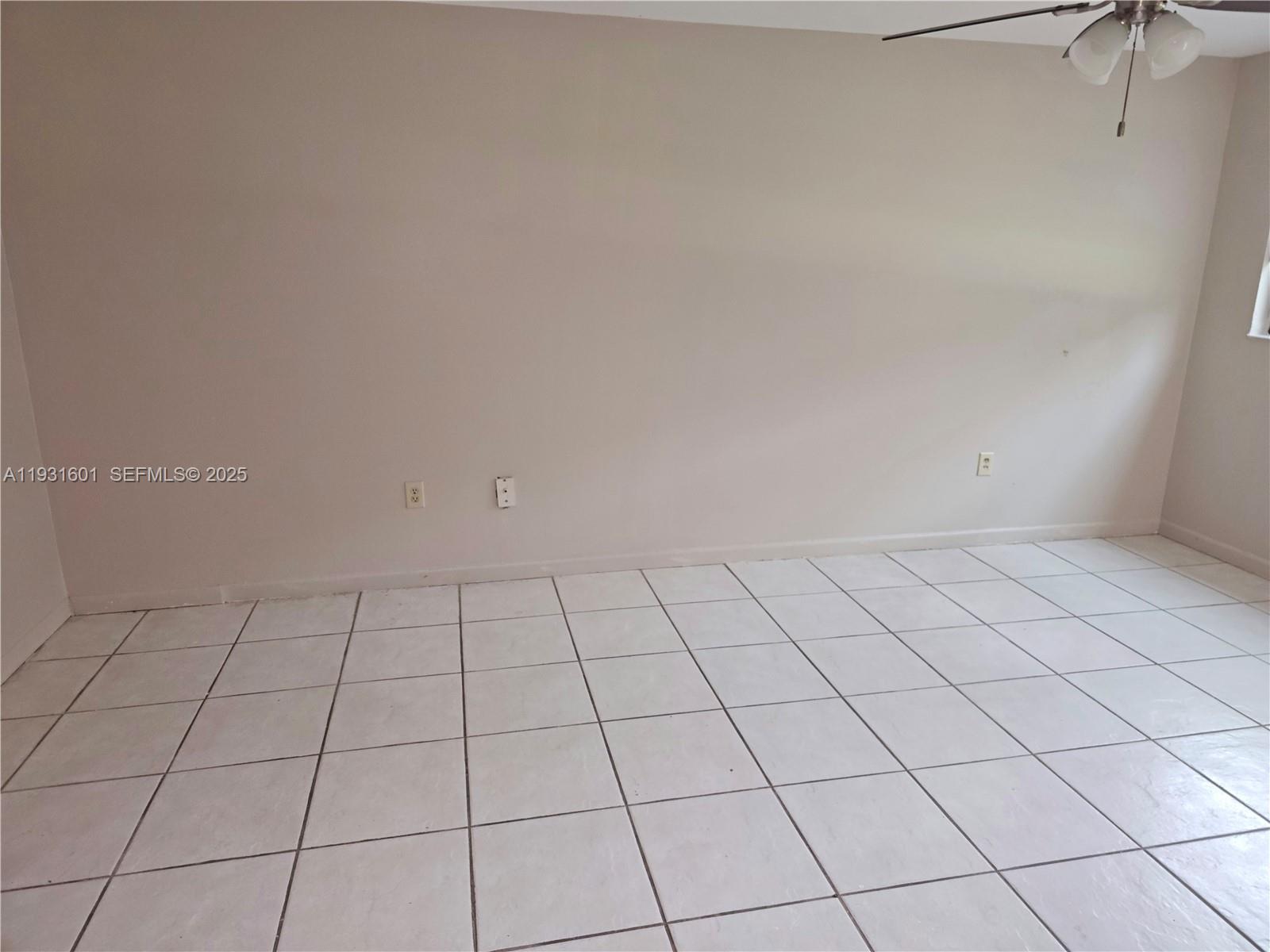 An empty room features light-colored walls, white tiled flooring, and a ceiling fan — 8415 SW 107th Ave # 116W, Miami FL 33173, MIAMI, FL